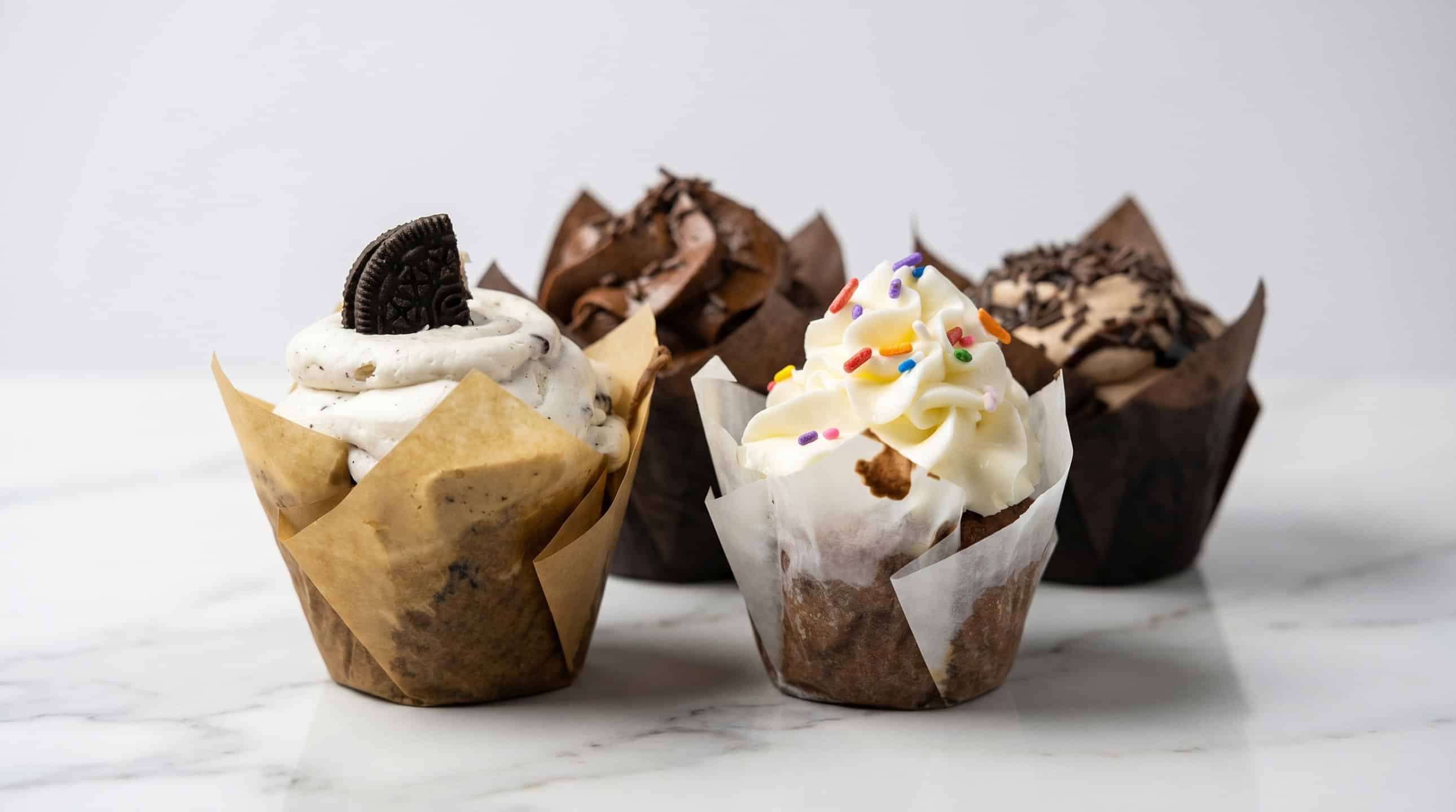An assortment of beautifully decorated Nan's Nummies custom cupcakes